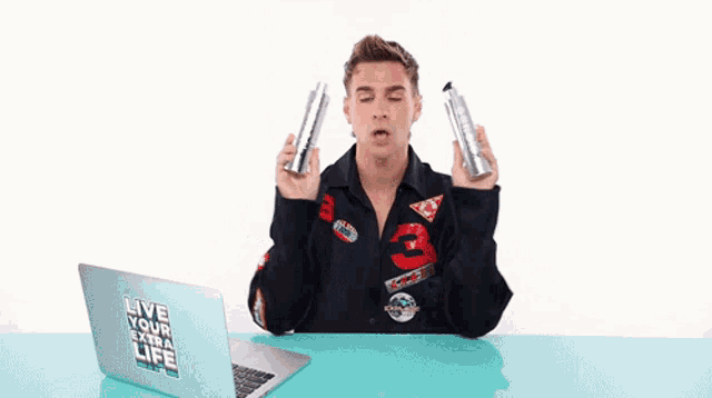 a man wearing a jacket with the number 3 on it is holding two bottles