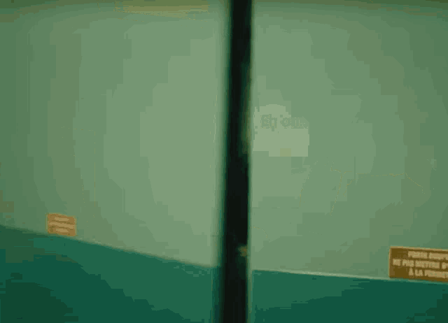 two men are kissing each other in a room in a blurry photo .