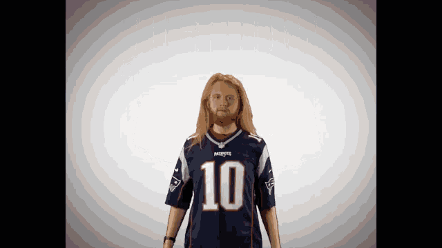 a man wearing a patriots jersey with the number 10