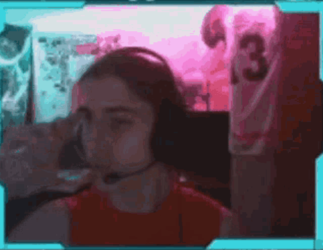 a girl wearing headphones with a microphone and a jersey with the number 3 on it