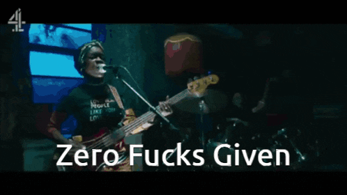 a man singing into a microphone and playing a guitar with the words zero fucks given