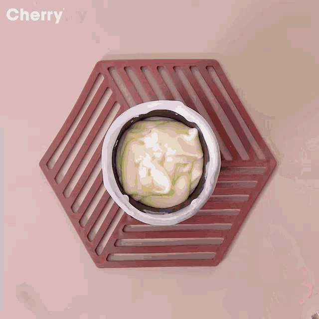 a bowl of blueberries is being poured into a wooden cup