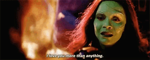 a woman with a green mask on her face is talking to a man .