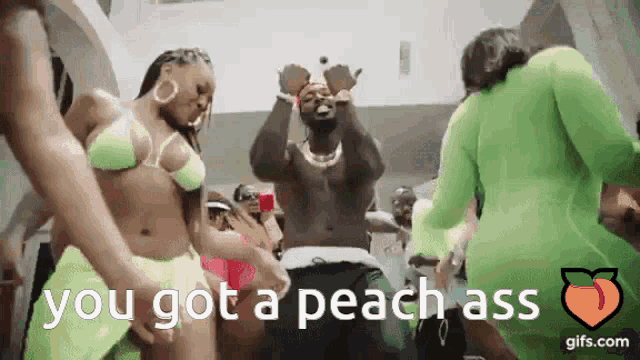 a group of people are dancing with the words `` you got a peach ass '' in the background .