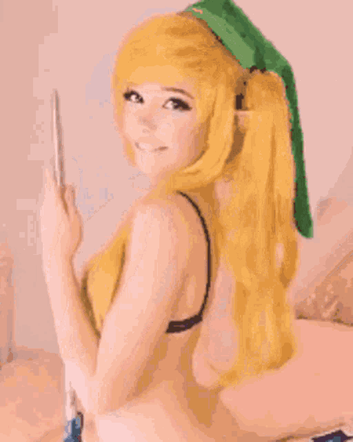 a woman in a link costume is holding a cell phone
