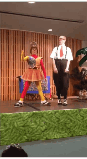 a man and woman are dancing on a stage