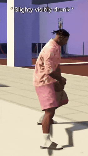 a man in a pink shirt and pink shorts is slightly visiblely drunk