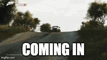 a car driving down a road with the words coming in