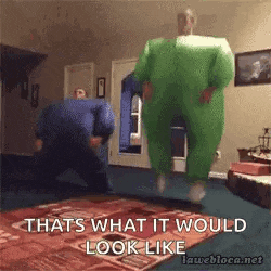 a man in a green inflatable suit is jumping in the air .
