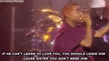 a man singing into a microphone with the words if he can 't learn to love you , you should leave him