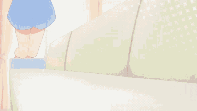 a person in blue shorts is standing next to a couch