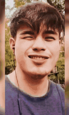 a close up of a man 's face with his eyes closed smiling