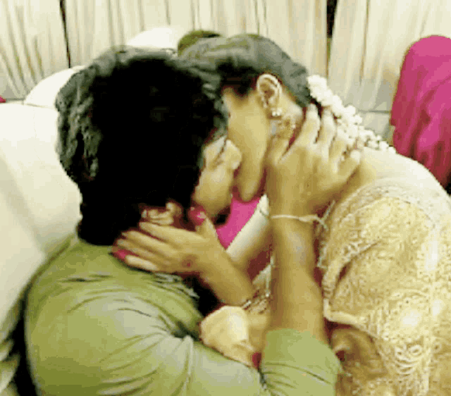 a man and a woman are kissing each other