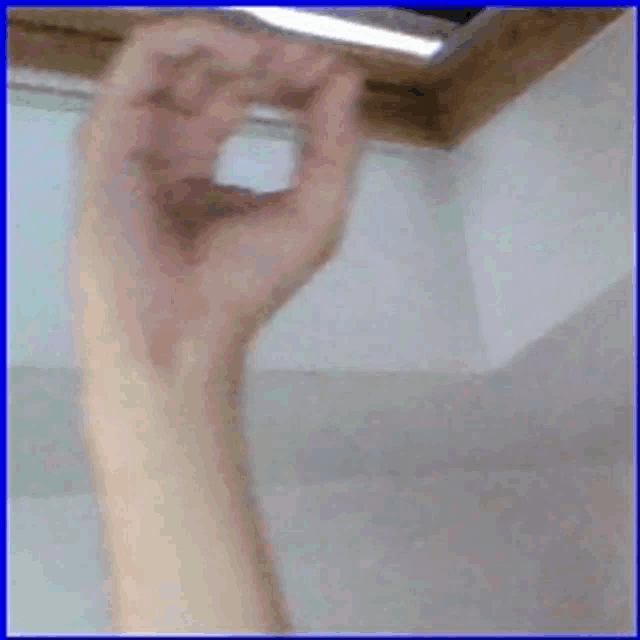 a close up of a person 's hand holding something in their hand