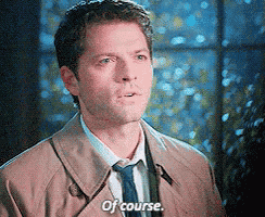 a man in a trench coat and tie is saying " of course "