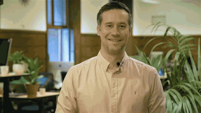a man wearing a pink shirt with a y on it