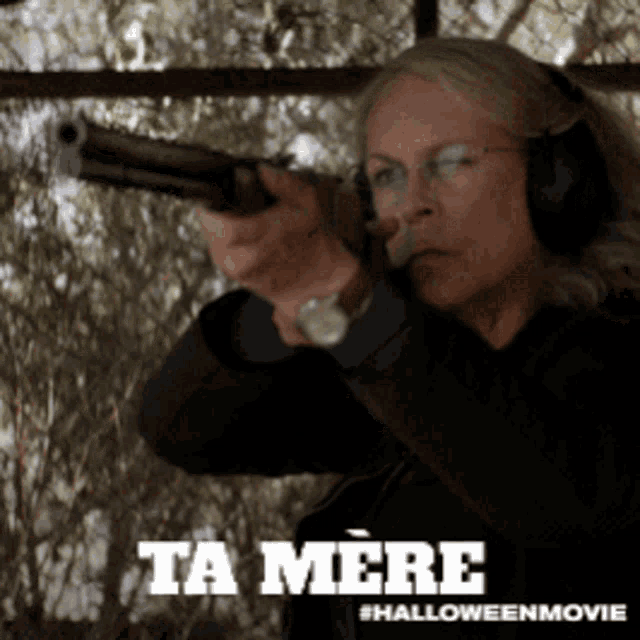 a woman wearing headphones is pointing a gun with the words ta mere in the corner