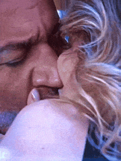 a close up of a man and woman kissing