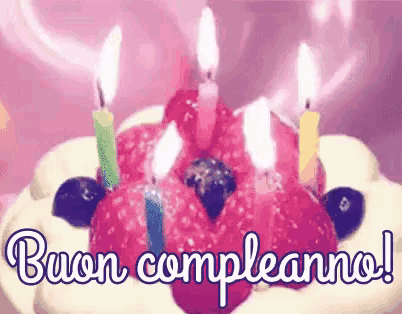 a birthday cake with candles and the words buon compleanno written on it