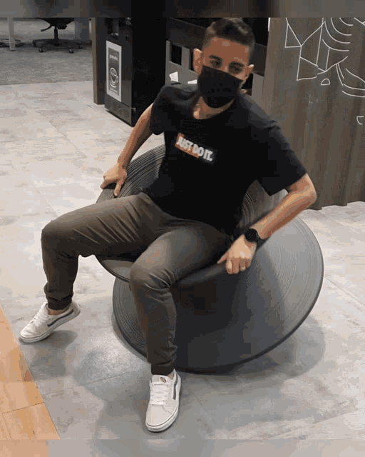 a man wearing a mask and a shirt that says just do it