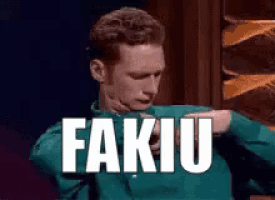 a man in a green shirt is dancing with the word fakuu above him .