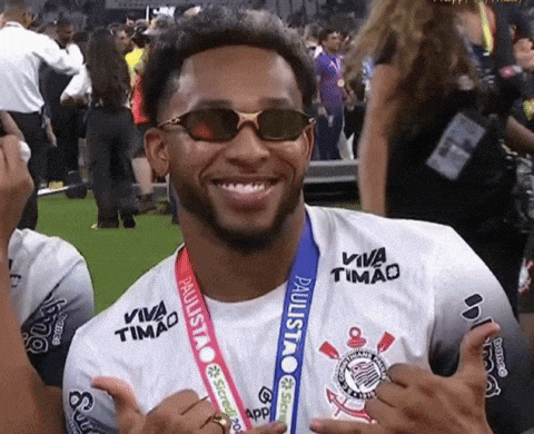 a man wearing sunglasses and a medal that says viva timado