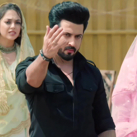 a man with a beard wearing a black shirt is making a rude gesture