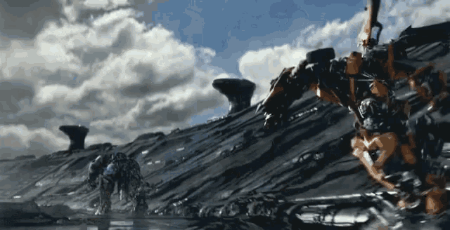 a group of robots are standing on top of a rocky hill .