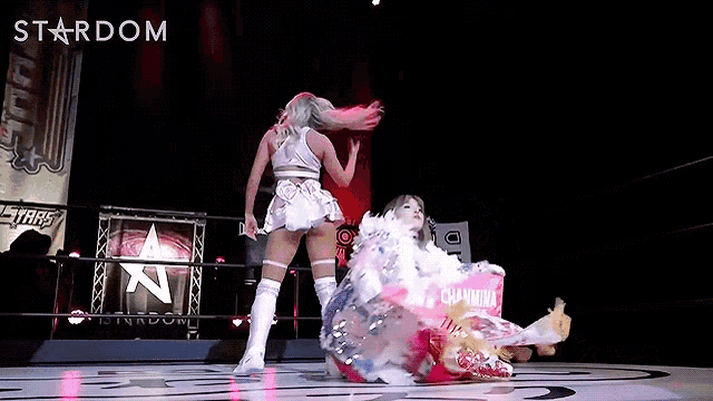 two women are wrestling in a ring with a sign that says stardom in the background