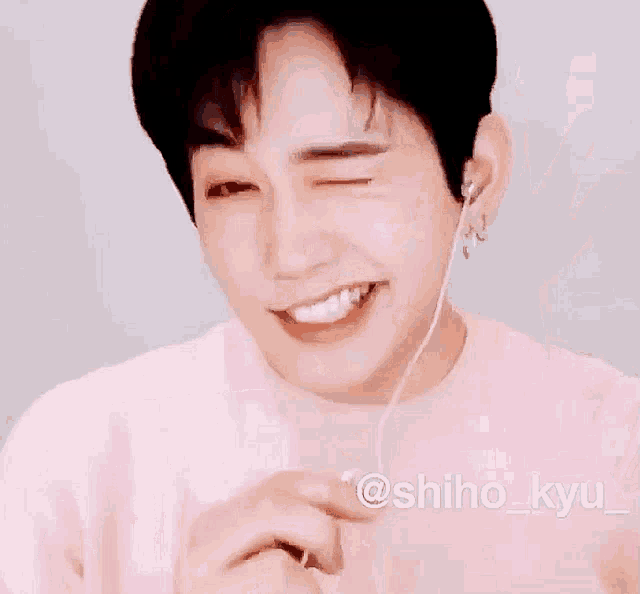 a man in a pink shirt with a pink sticker that says ok
