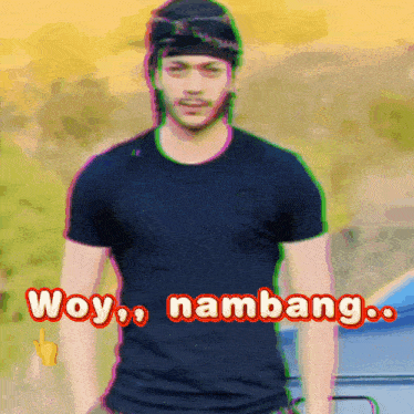 a man wearing a black shirt with the words woy nambang written on the front
