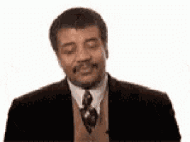 a man in a suit and tie is making a funny face with his eyes closed .