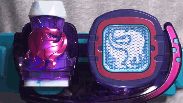 a purple and pink toy with a snake design on it
