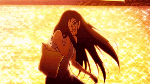 a woman with long hair is walking on the beach .