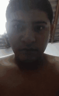 a man without a shirt is looking at the camera with his mouth open