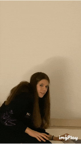 a girl with long hair wearing a black shirt that says ' sx3 ' on it