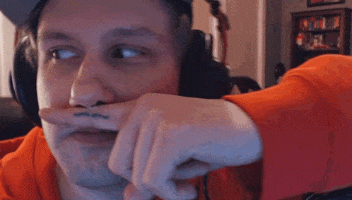 a man wearing headphones has a tattoo on his finger that says ' i love you '