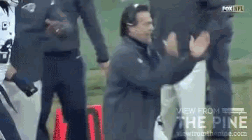 a man is kneeling down in front of a fox nfl football game