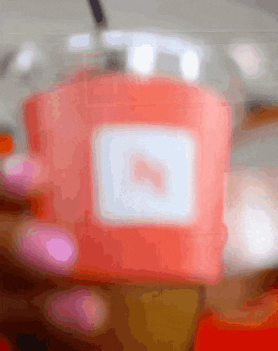a blurred image of a red box with a white square with a heart on it