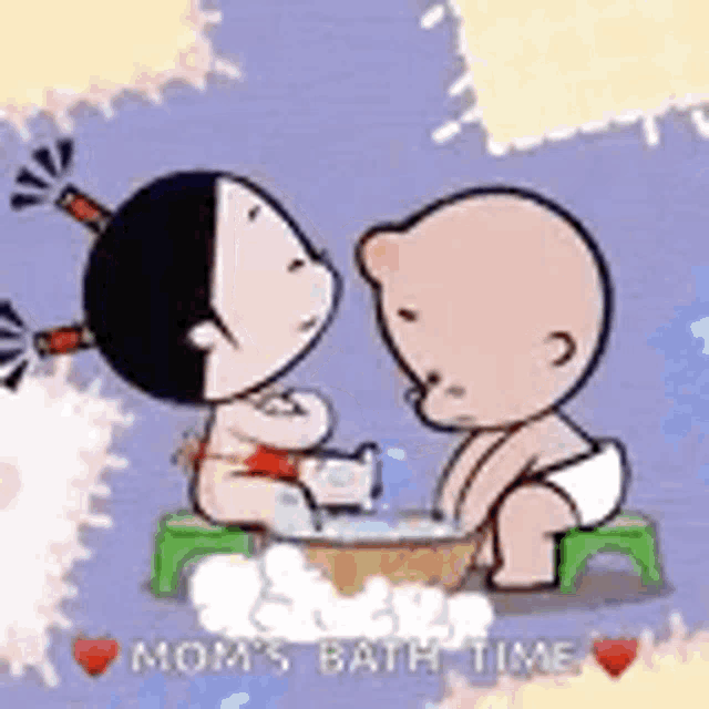 a boy and a girl are taking a bath together in a bowl .
