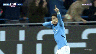 a soccer player celebrates a goal in front of a crowd