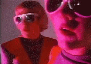 a couple of people wearing sunglasses are standing next to each other