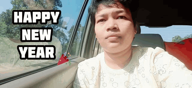 a man sitting in a car with the words happy new year on the bottom