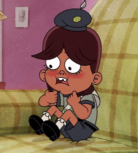 a cartoon character sitting on a couch with a hat on his head