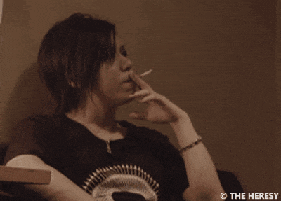 a person smoking a cigarette with the heresy watermark