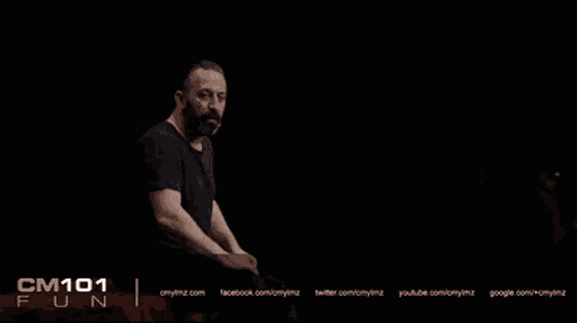 a man in a black shirt stands in front of a black background that says bu bir saka olmali