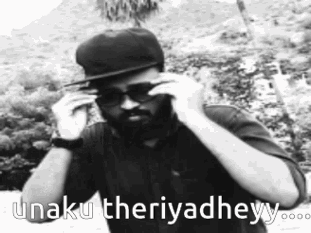 a man wearing sunglasses and a hat with the words unaku theriyadheyy
