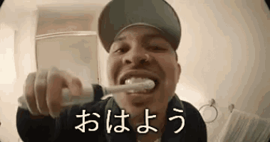 a man is brushing his teeth with an electric toothbrush .