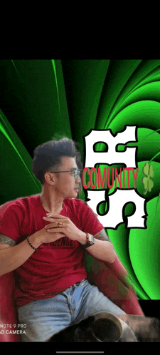 a man in a red shirt is sitting in front of a green background with the word community written on it