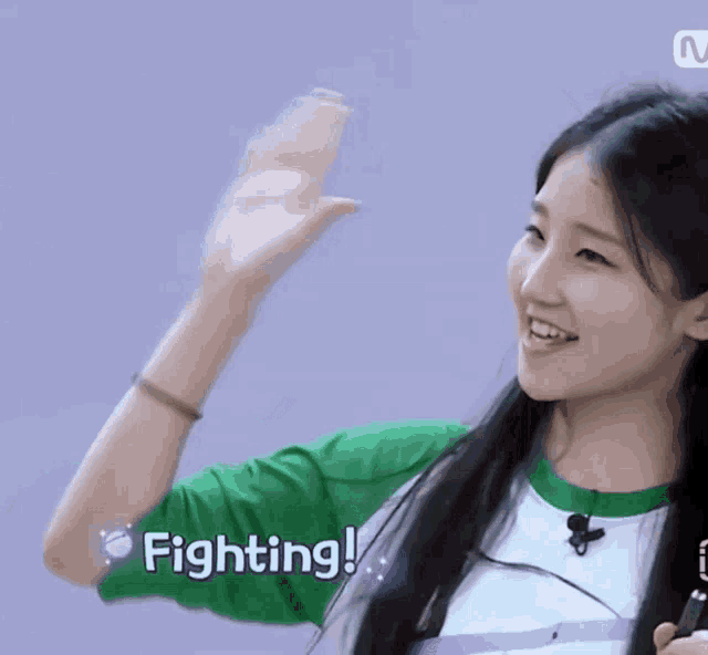 a girl with a green shirt that says fighting on it